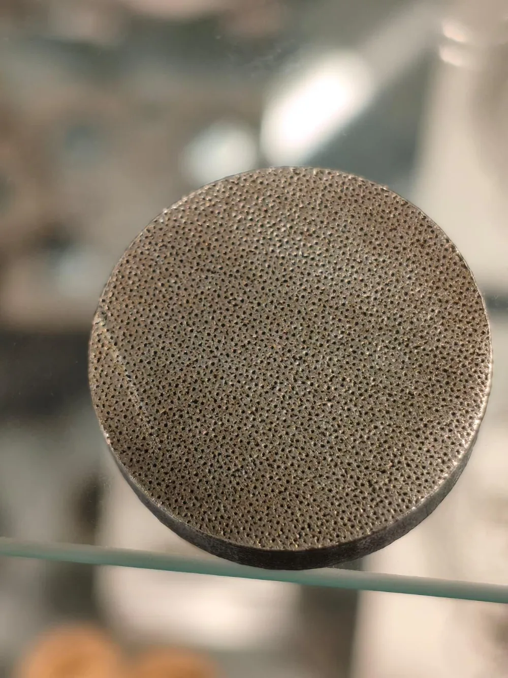 LPBF manufactured disc with a micro-perforated top surface